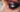 Close-up of a wet-look metallic goth eye with glossy shimmer eyeshadow catching the light