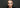 Model with a dark smoky halo eye and a shimmering centre, photographed against a black background